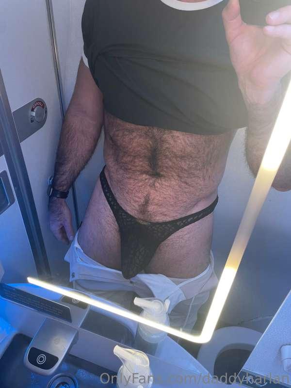 A front and back view of this reticulated black thong in the..