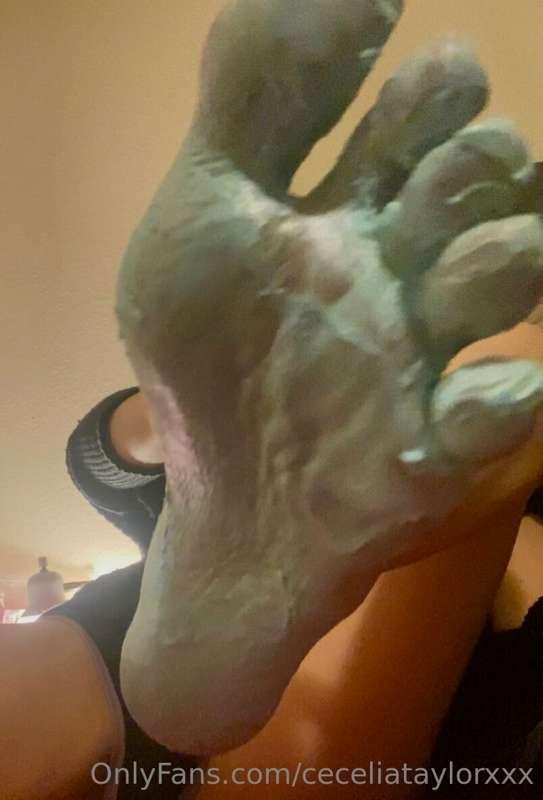 Rubbing blue foot mask all over my feet & in between my red ..