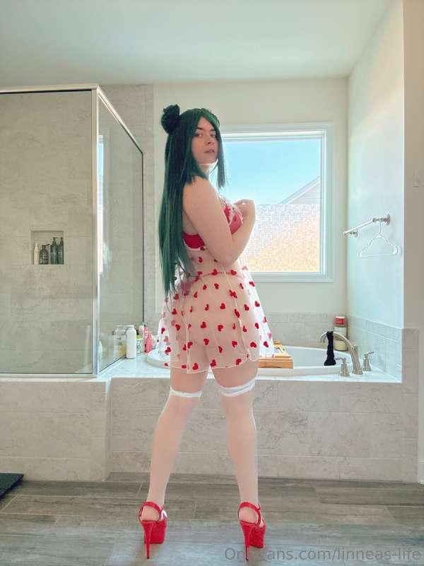 White sheer dress with red Hearst and long dark green wig pi..