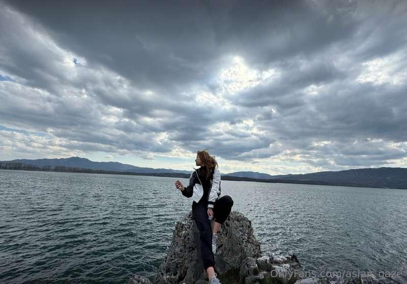 Above, the heavens are painted in shades of gray, as if mirr..