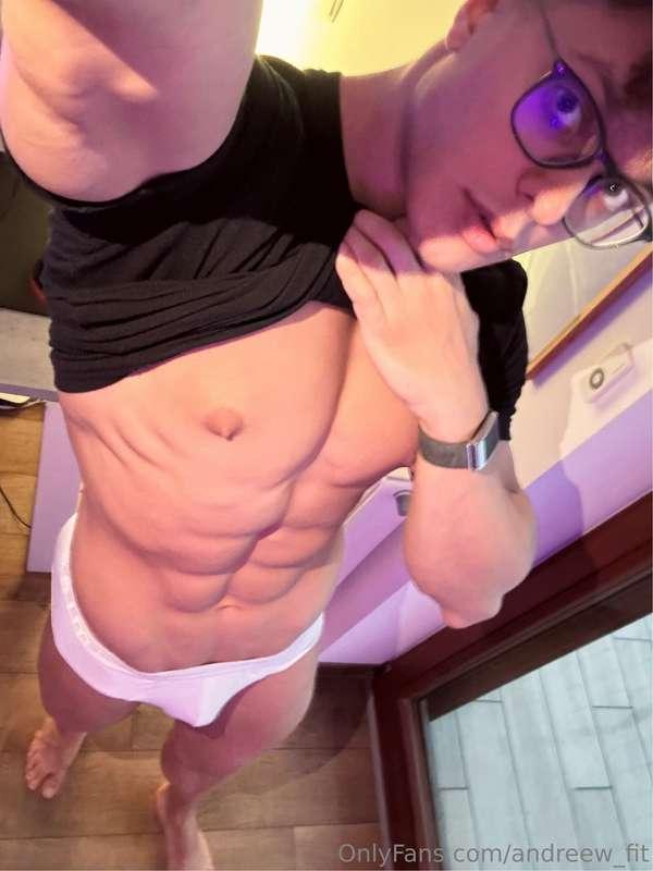 Shirt lifted to show the abs, white briefs barely holding th..