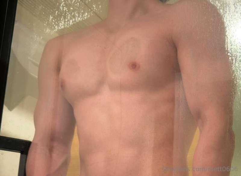 Pectoral muscles pressed against glass.