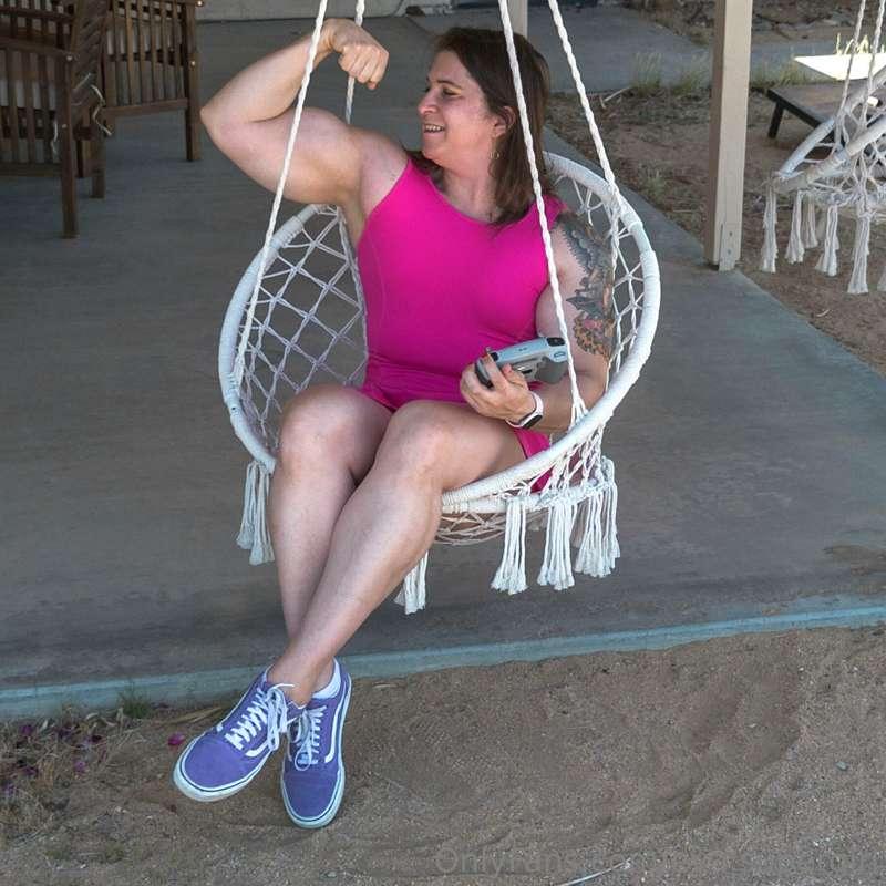 Eva gracefully settles into the rustic swinging chair, but i..