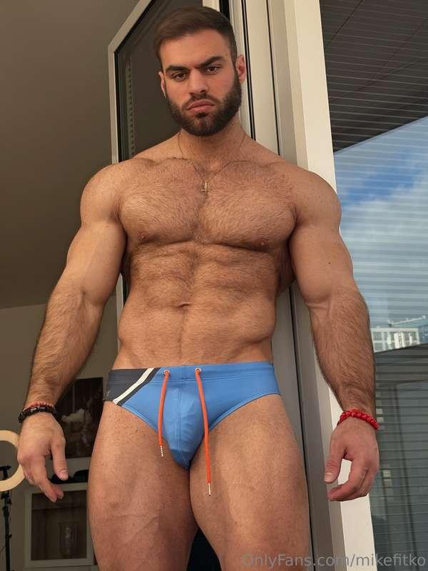 Abs tight, biceps pumped, cock straining in my brief how lon..