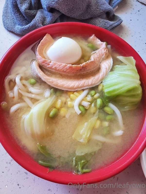 Udon noodles with salmon, cabbage, egg, corn, and edamame in..