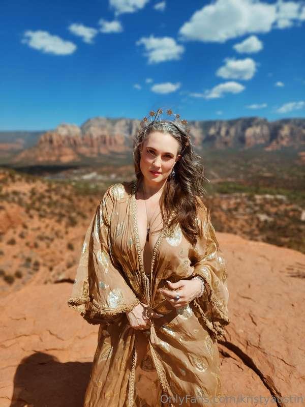 She stands atop the mountain, a goddess of earth and sky, wi..