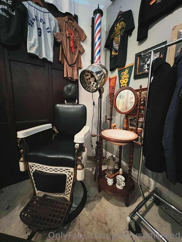 A turn-of-the-century barber chair and accompanying supplies..