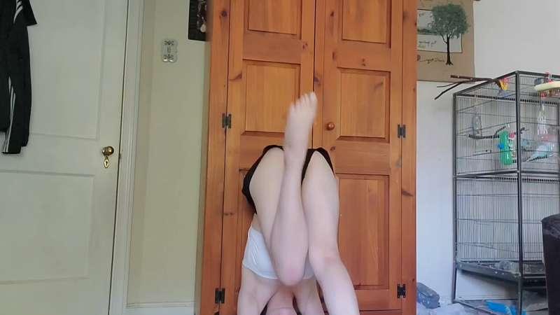 Straddle headstand against the wall 