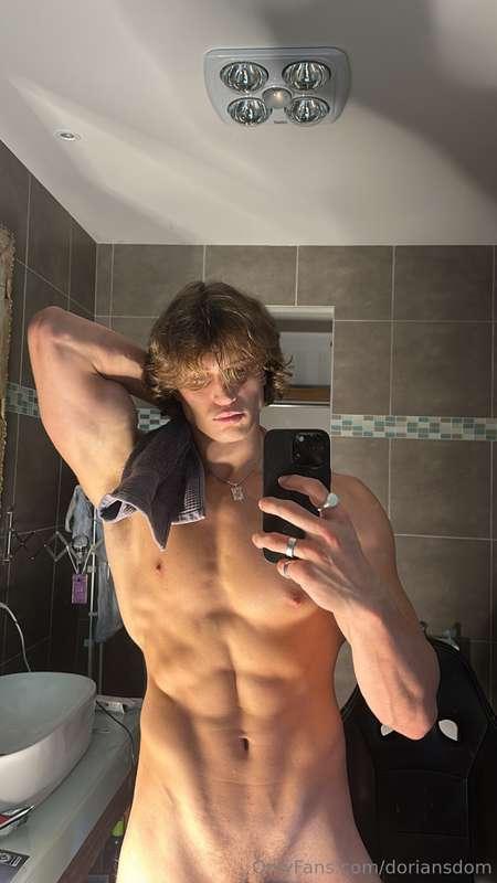 Mirror catching the flex, body bare, and just enough hidden ..