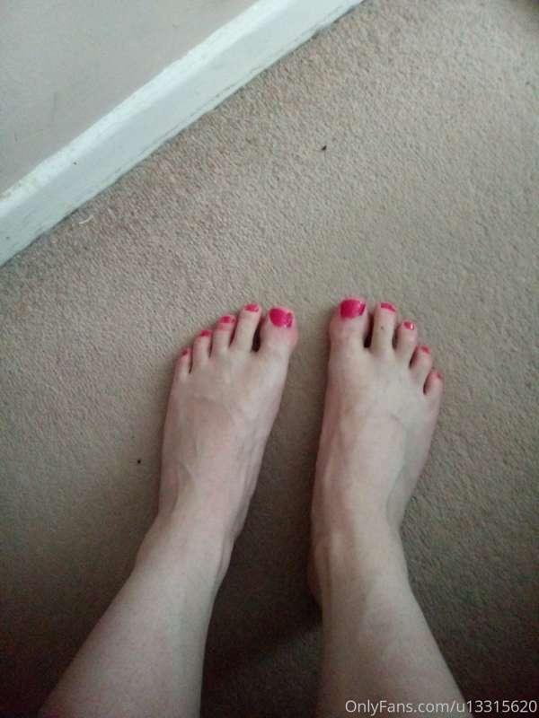 Crossdressing sissy femboy with painted pink toe nails