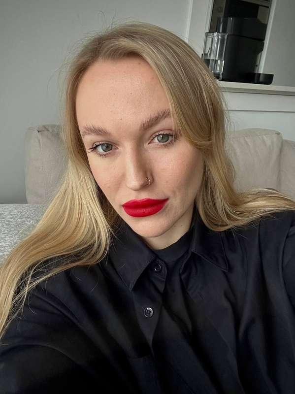 Red lips as a warning, black shirt as a dare.So tell me — am..