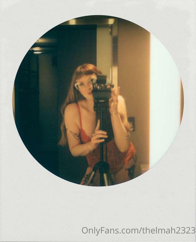 The woman behind and in front of the camera