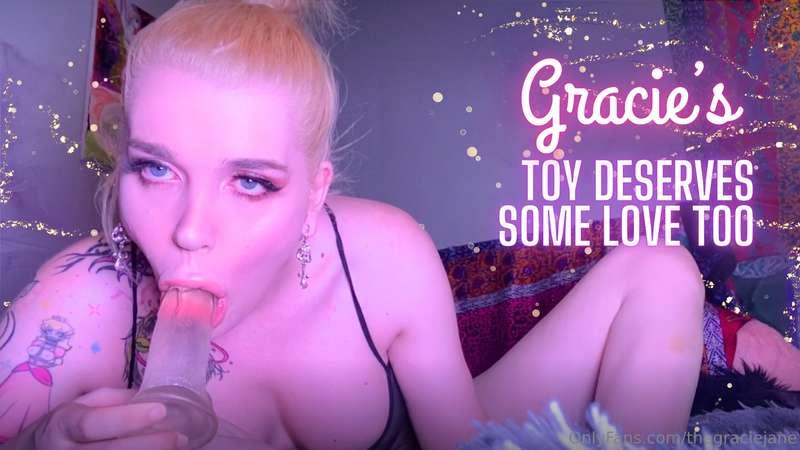 I'm laying back on my bed, gagging on my toy while it slides..
