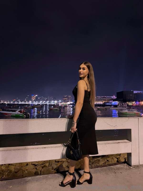 Chic and elegant, walking along the night glowing promenade...