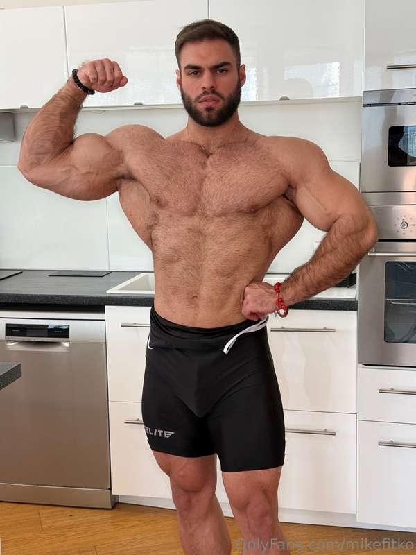 Flexing biceps, shorts tight, and this fat cock making itsel..