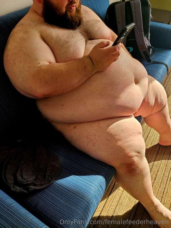 Basking in the sun, letting his flab fly free, enjoying a ni..